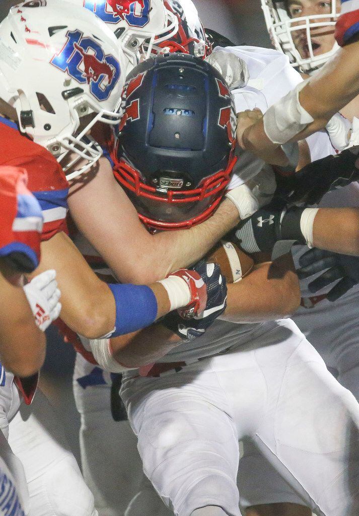 Northwest's Kyndel Sims (10) gets wrapped up by Grapevine's defense  during the second half...