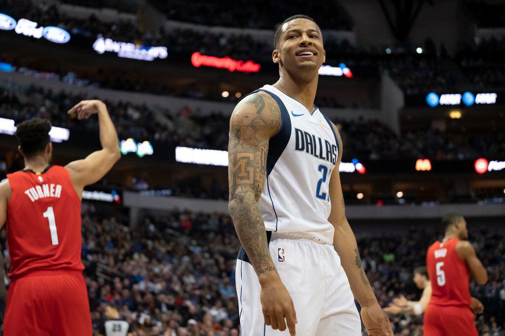 Dallas Mavericks guard Trey Burke reacts after bing called for a foul during the second half...