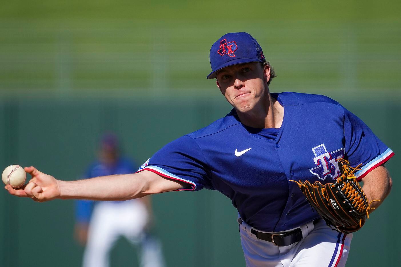 Texas Rangers pitcher Chase Lee delivers during the eighth inning of a spring training game...