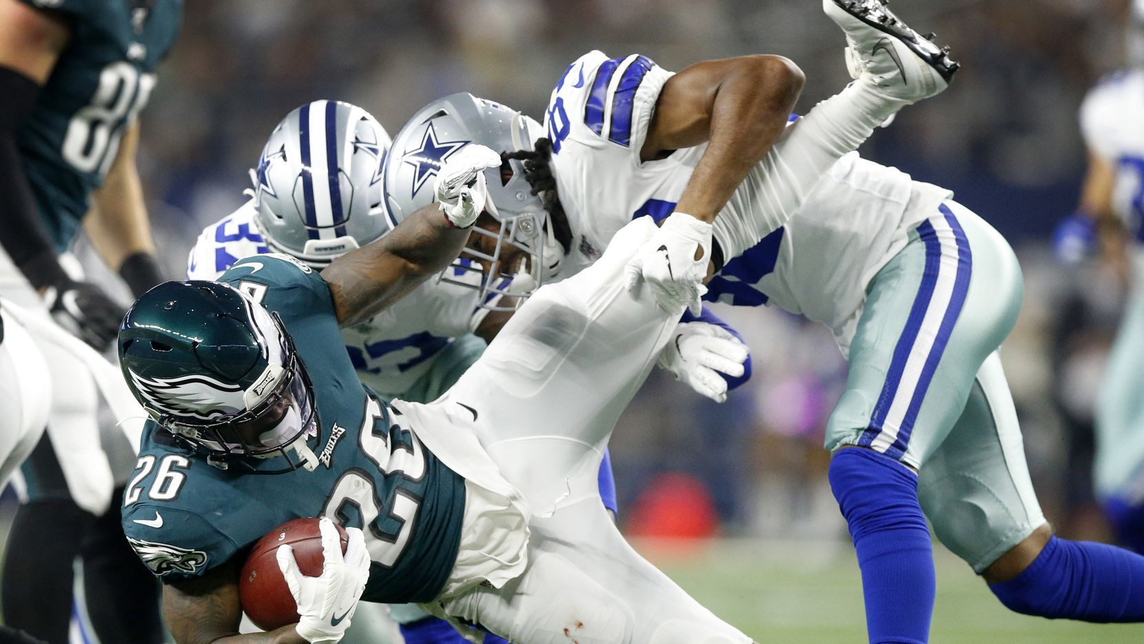FILE - Cowboys wide receiver Ventell Bryant (83) and defensive back Donovan Wilson (37) drop...