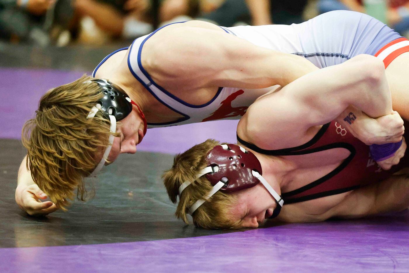 Louden Park of Grapevine (top) wrestles with Carter Webster of Frisco Heritage during 5A...