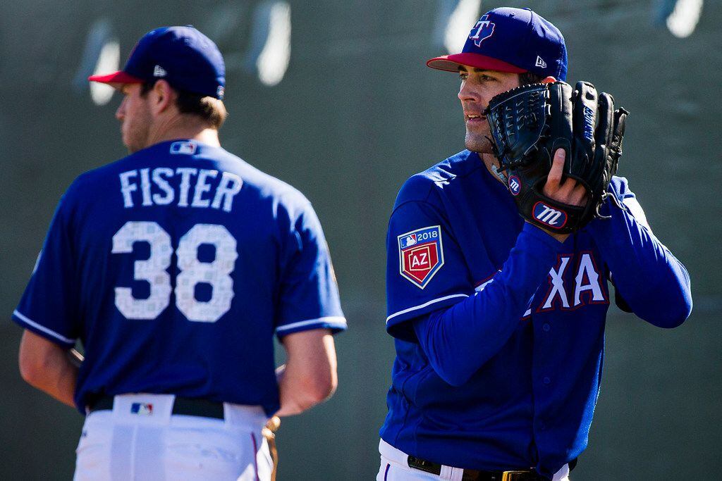 Texas Rangers pitchers Cole Hamels (35) and Doug Fister (38) throw in the bullpen during a...