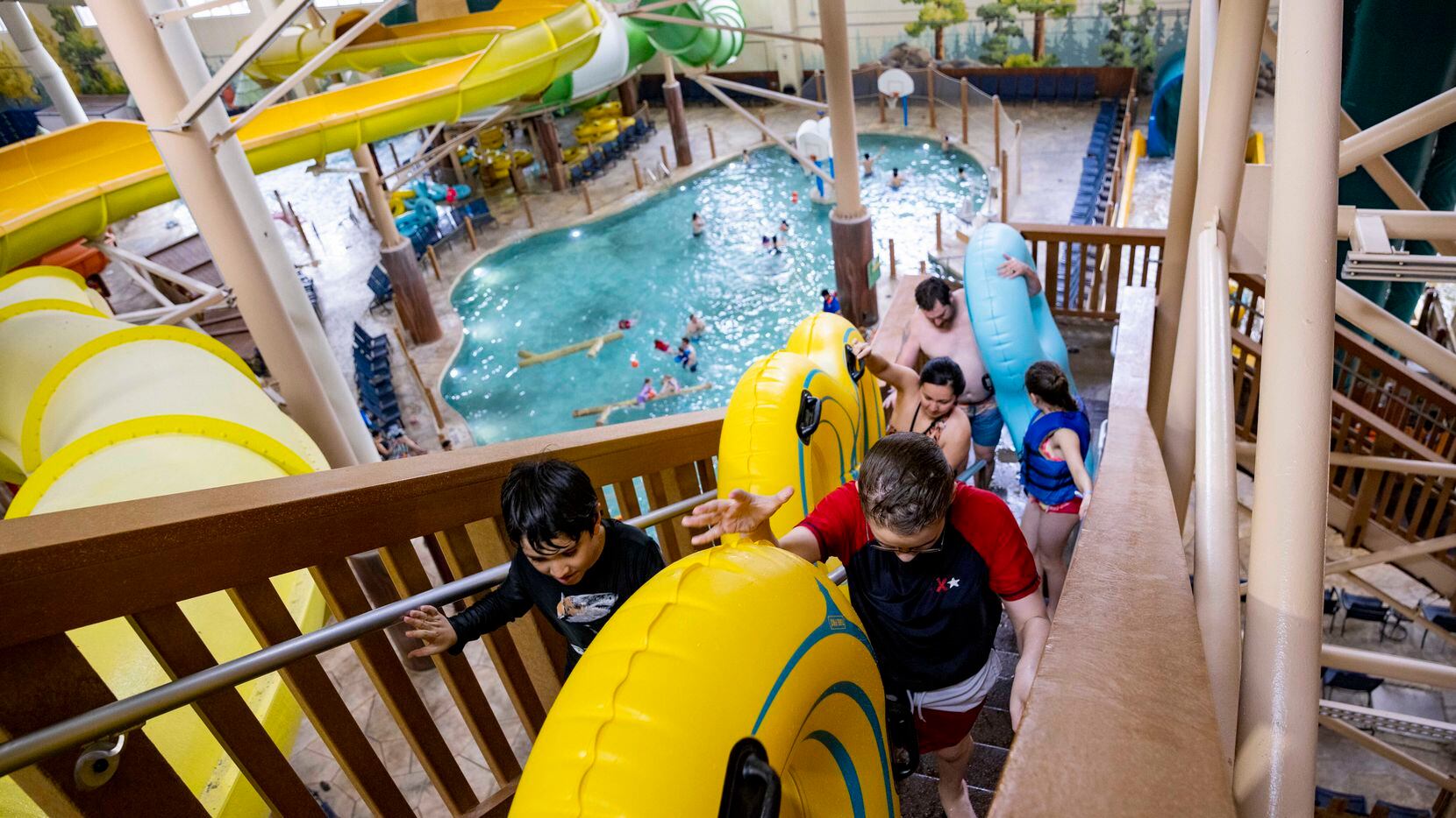 People climb the stairs to ride the slides at Great Wolf Lodge in Grapevine on Thursday,...