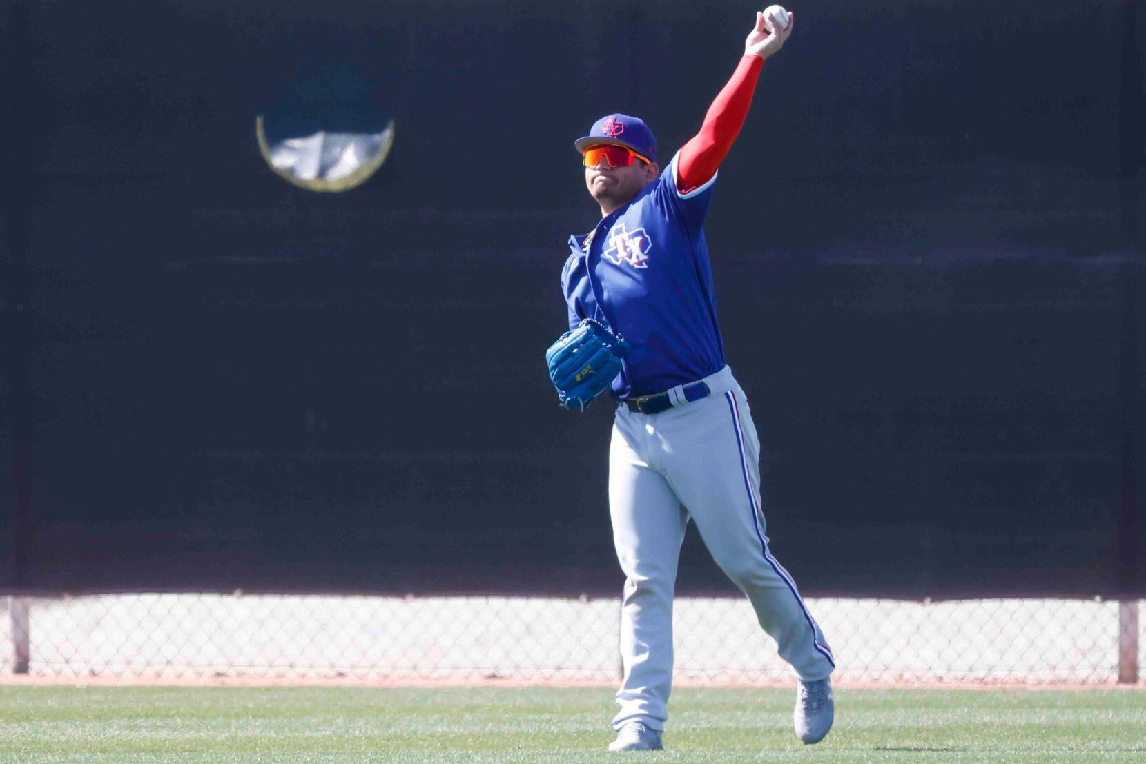 Texas Rangers minor league outfielder Alejandro Osuna takes part in a fielding practice...
