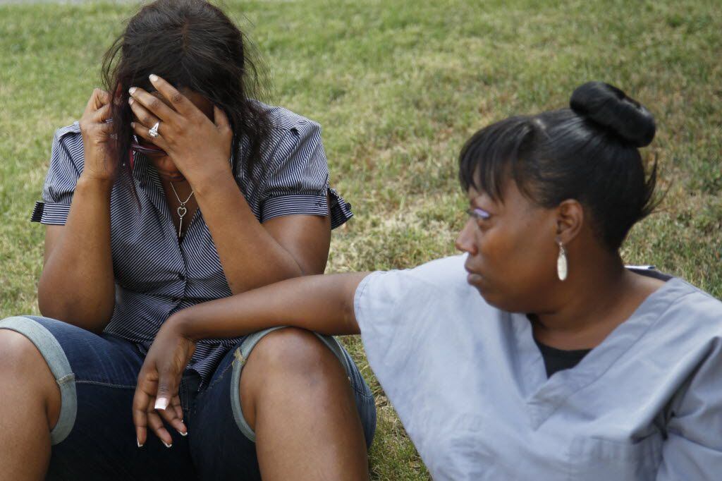 Sonya Ellington (left) and Marquisha Webb, friends of Zina Bowser and her family, waited on...