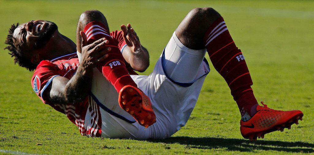 FC Dallas midfielder Kellyn Acosta (23) reacts after tripping in a collision with Los...