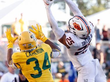 Oklahoma State safety Jason Taylor II (25) intercepts a pass intended for Baylor wide...
