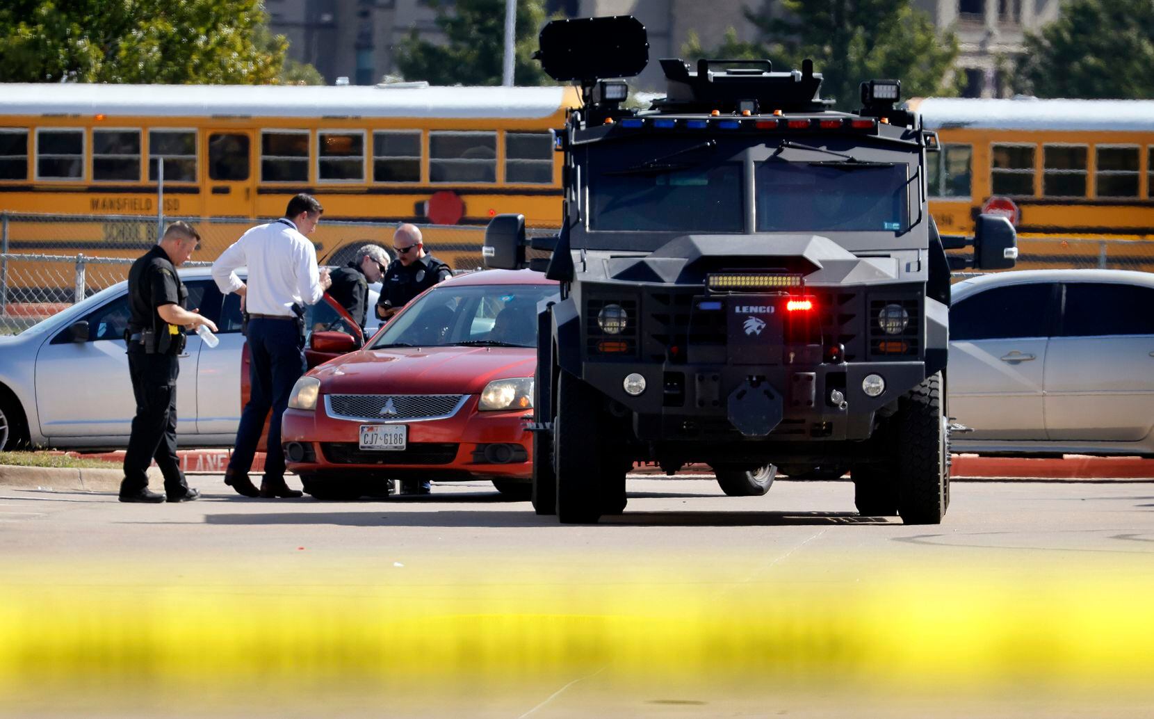 Police officials work the scene of a school shooting at Mansfield Timberview High School in Arlington, Texas, Wednesday, October 6, 2021. Four people were injured in a shooting at Timberview High School in Arlington on Wednesday morning, and authorities said the suspect remained at large. (Tom Fox/The Dallas Morning News)