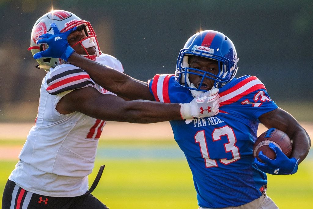Duncanville wide receiver Roderick Daniels (13) pushes past St. John's College (D.C.) defensive back Xavier Terry (10) during the first half of a high school football game on Saturday, Sept. 14, 2019, in Duncanville. (Smiley N. Pool/The Dallas Morning News)
