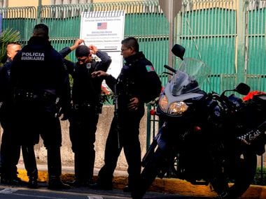 Members of the Mexican Police stand guard outside the US Consulate in Guadalajara, Mexico on...