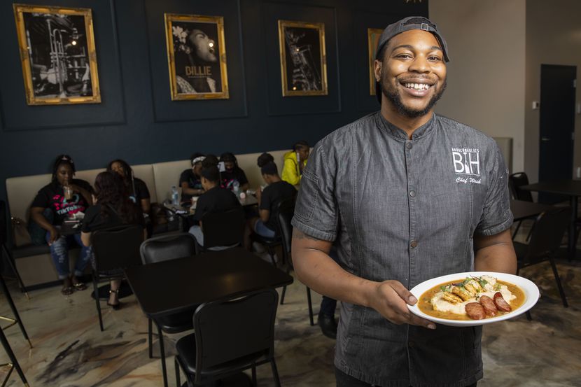Brunchaholics owner Jessie Washington poses with his shrimp and grits with sausage at Soiree...