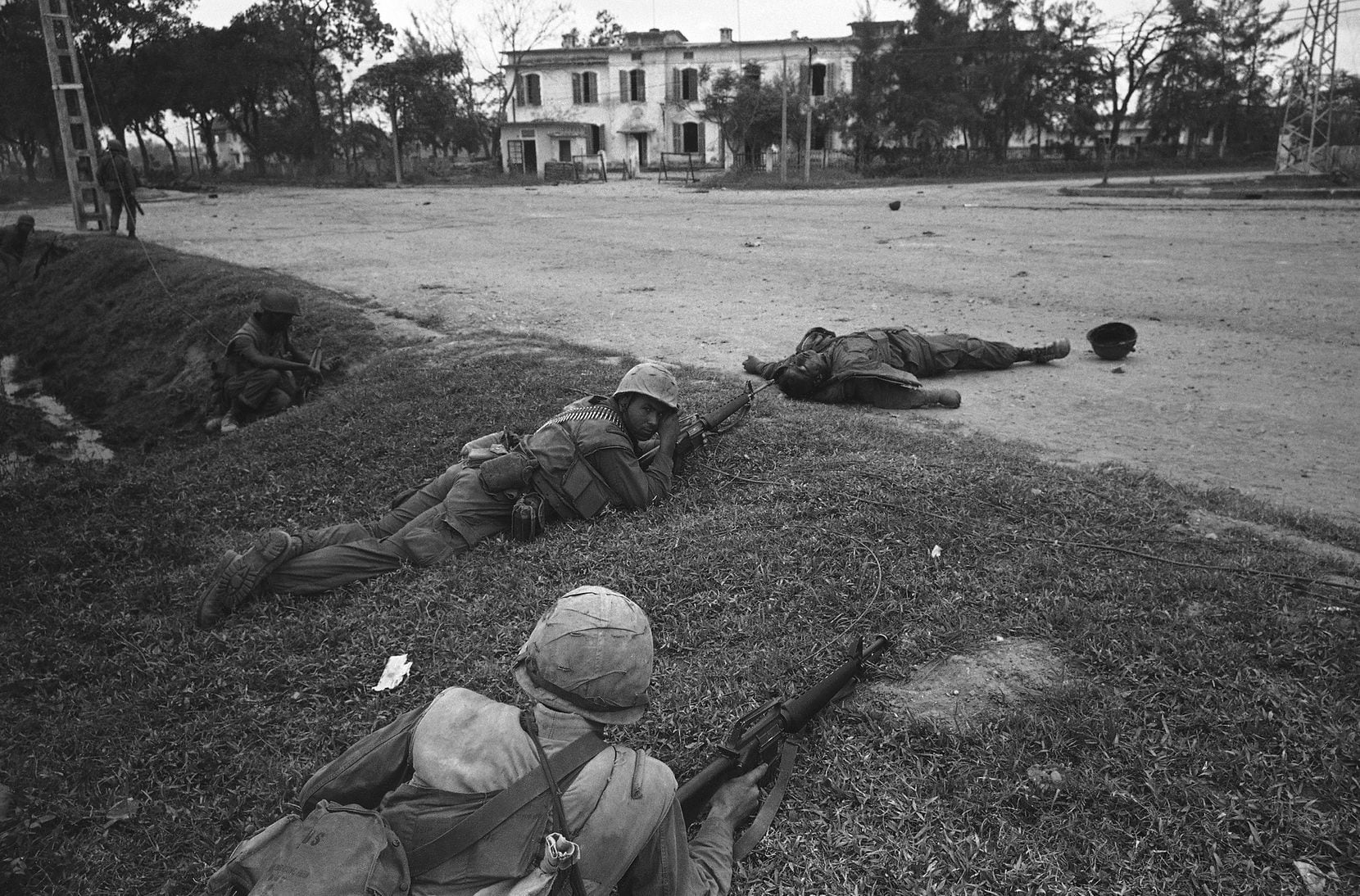 The U.S. Marines take up firing positions on the side of the road in downtown Hue, Vietnam...