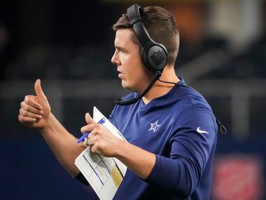 Dallas Cowboys offensive coordinator Kellen Moore gives thumbs up to quarterback Ben DiNucci...