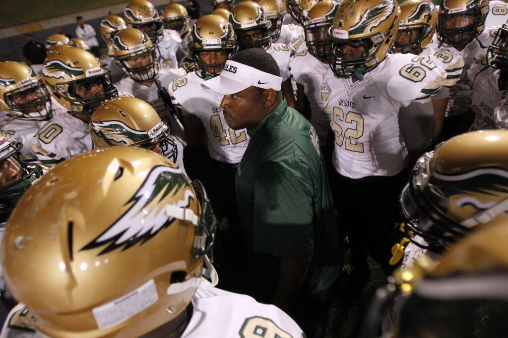 Desoto head coach Claude Mathis talks to his team before the start of the football game...