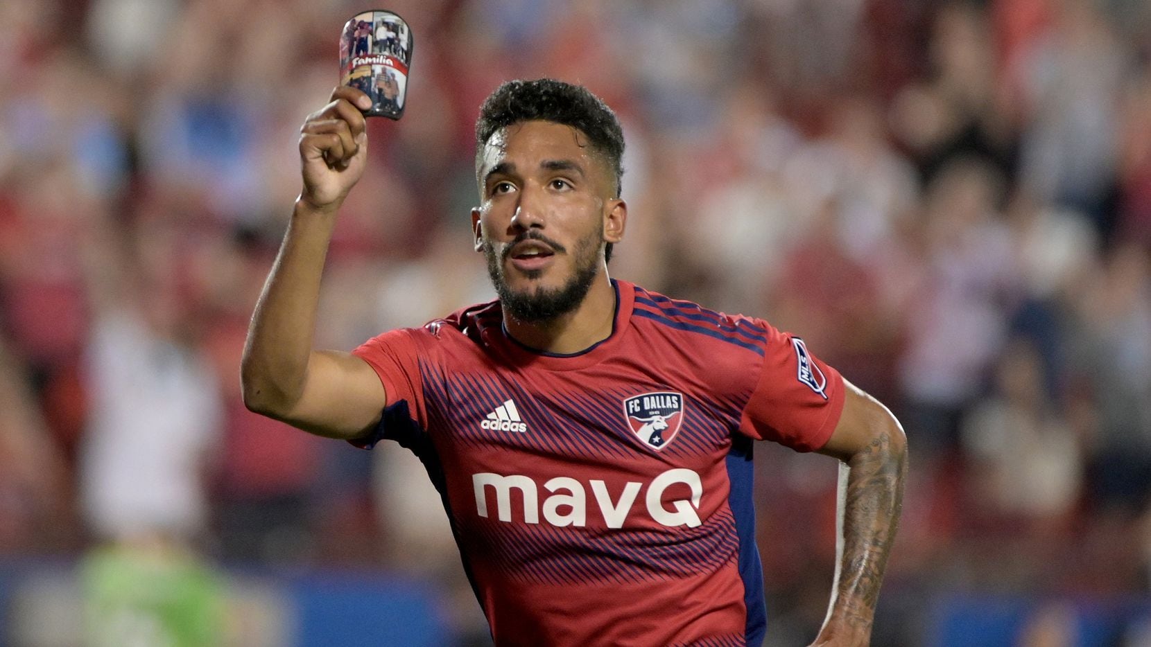 FC Dallas forward Jesús Ferreira (10) celebrates a goal while holding a picture of his...