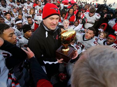Cedar Hill head coach Joey McGuire accepts the Class 5A Division II state semifinal trophy after defeating Lake Travis at Floyd Casey Stadium in Waco, Saturday, December 14, 2013. Cedar Hill advanced to the State Final after winning, 19-10. (Tom Fox/The Dallas Morning News)