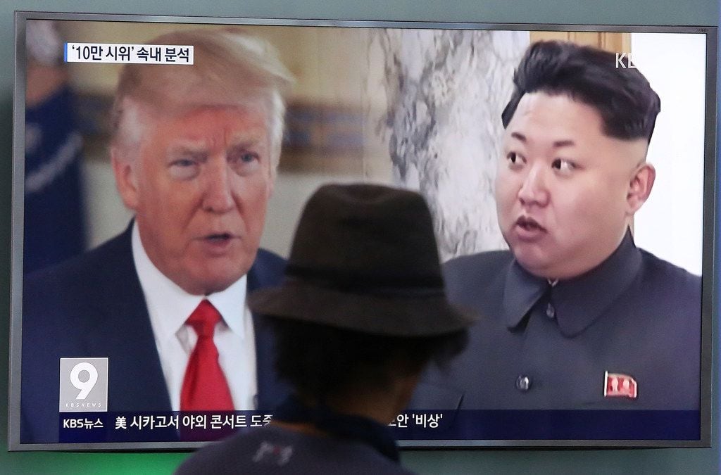 In this Aug. 10, 2017, file photo, a man watches a television screen showing U.S. President Donald Trump and North Korean leader Kim Jong Un during a news program at the Seoul Train Station in Seoul, South Korea.  South Korea's national security director says President Donald Trump has decided he will meet with North Korea's Kim Jong Un "by May." 