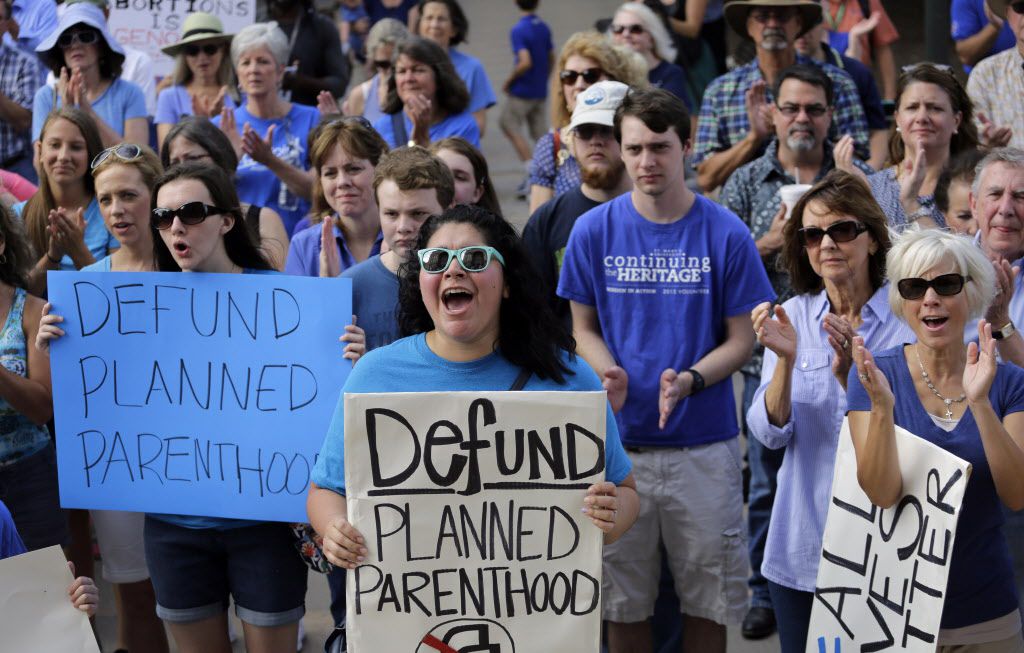 Erica Canaut (center) cheered as she and other anti-abortion activists rallied on the steps...