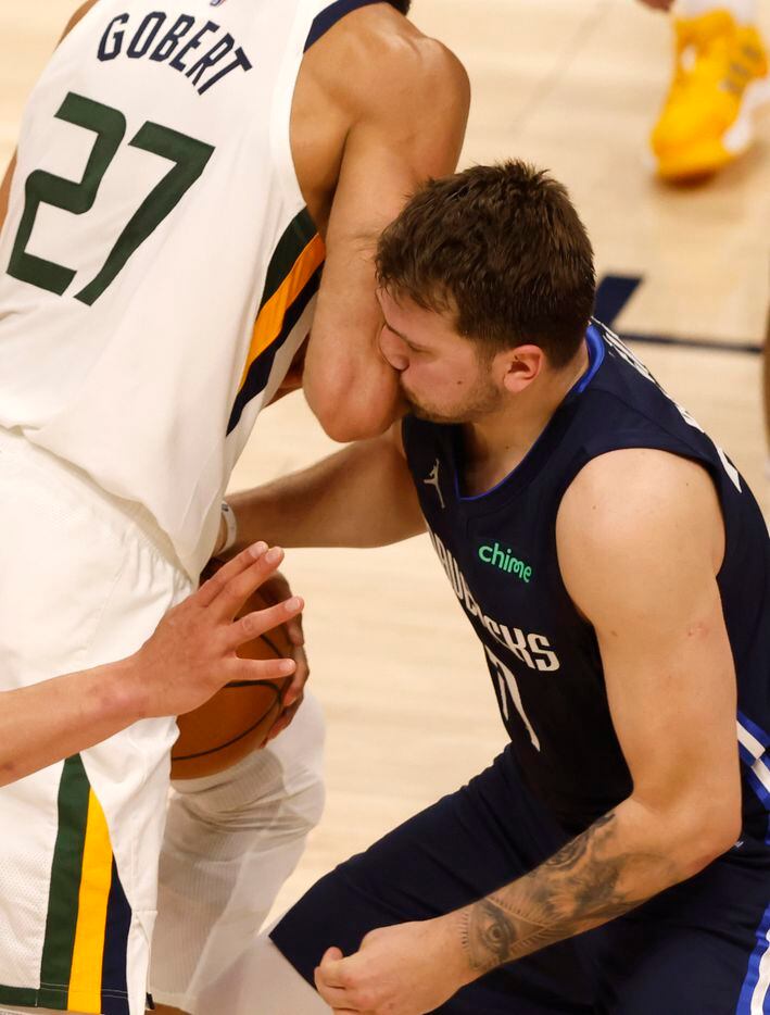 Dallas Mavericks guard Luka Doncic (77) gets hit in the face as he attempts to take the ball...
