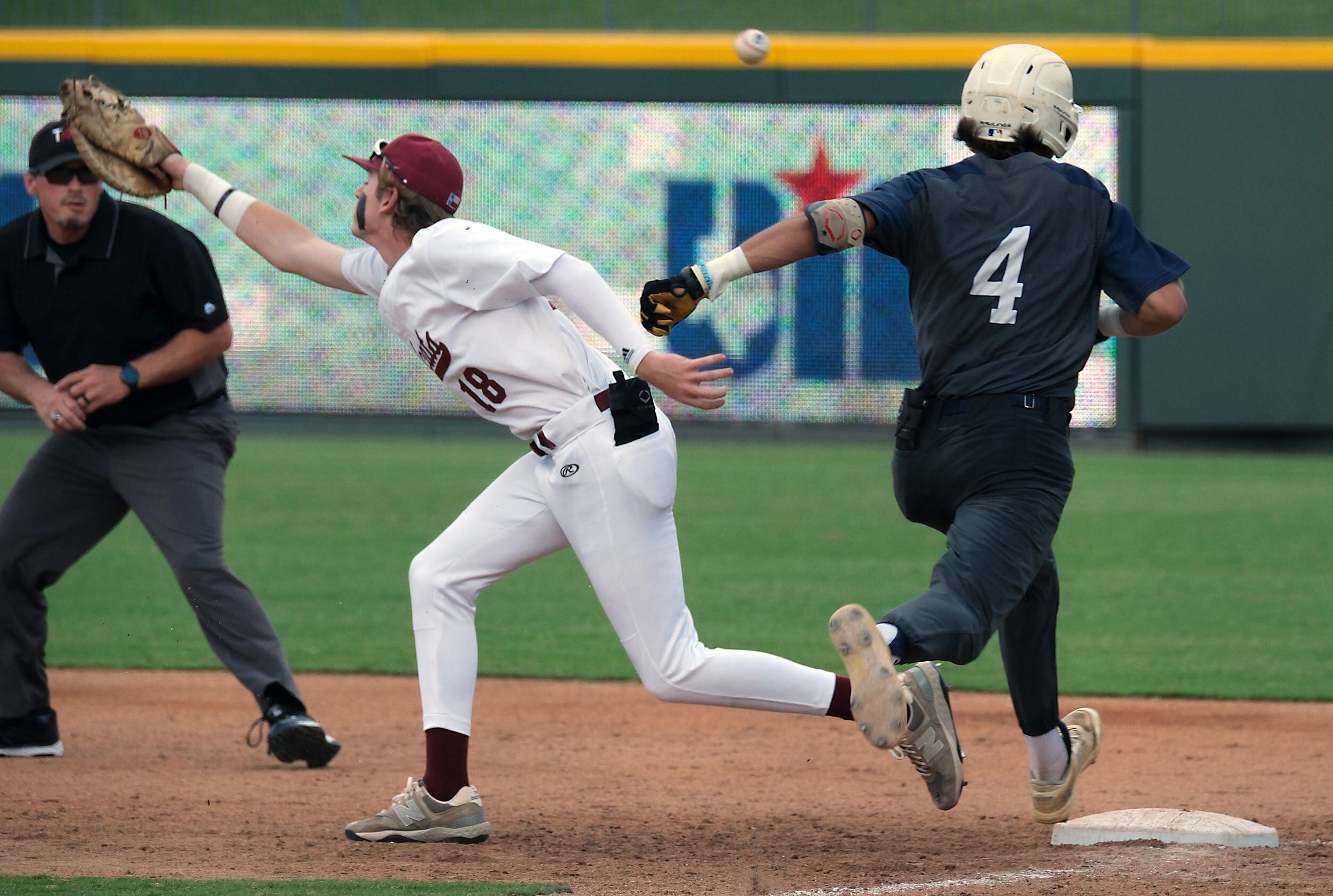 Flower Mound Ryder McDaniel, (4), makes it to safely to first base as Cypress Woods McClane...