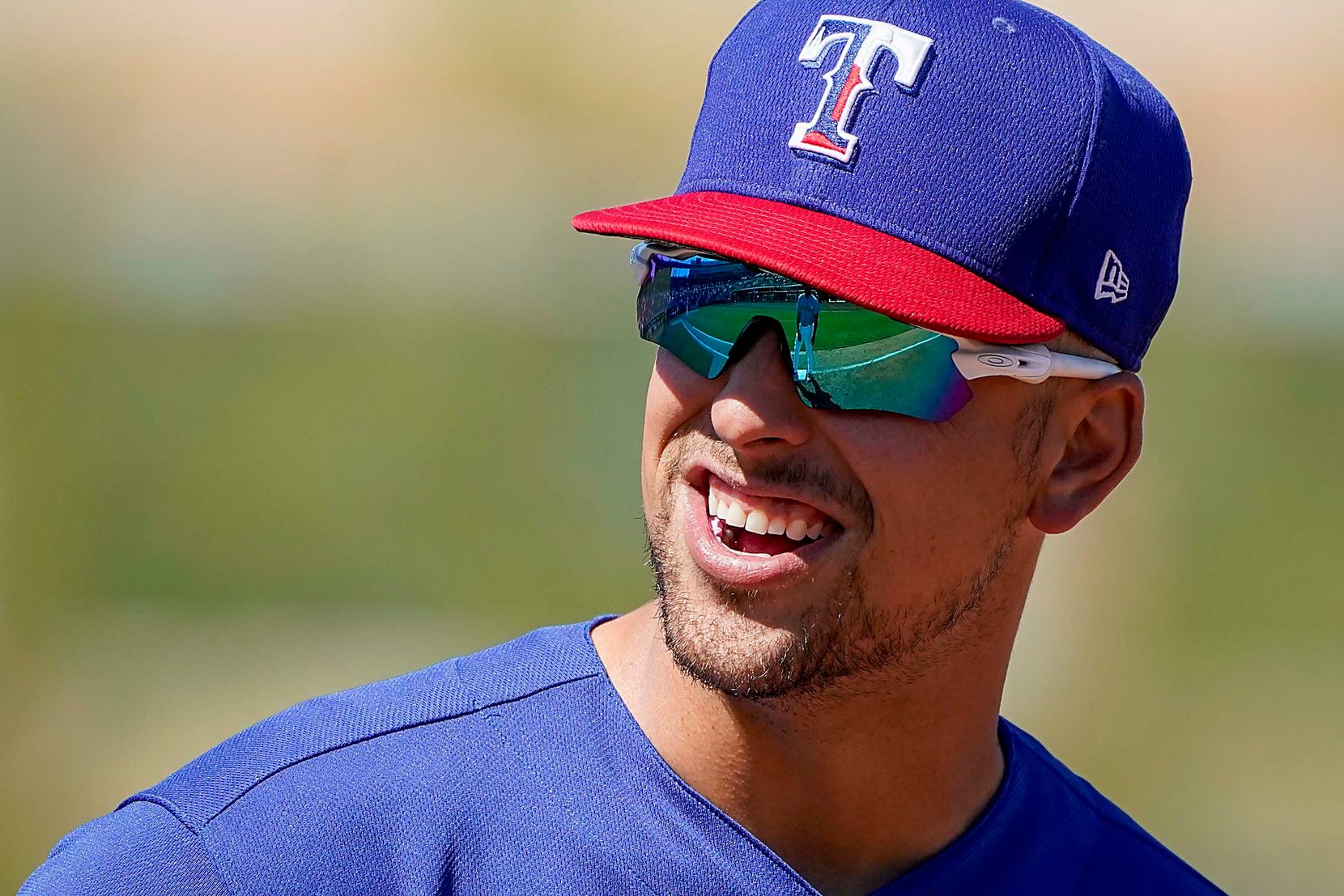 Texas Rangers first baseman Nate Lowe laughs with Seattle Mariners center fielder Taylor Trammell at first base during the second inning of a spring training game at Peoria Sports Complex on Wednesday, March 10, 2021, in Peoria, Ariz.