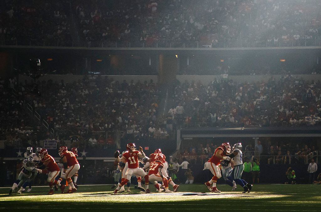 Kansas City Chiefs quarterback Alex Smith (11) gets off a pass as sunlight filters into the stadium during the first half of an NFL football game against the Dallas Cowboys at AT&T Stadium on Sunday, Nov. 5, 2017, in Arlington, Texas. (Smiley N. Pool/The Dallas Morning News)
