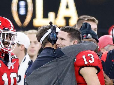 Georgia Bulldogs quarterback Stetson Bennett (13) receives a hug from his head coach Kirby...