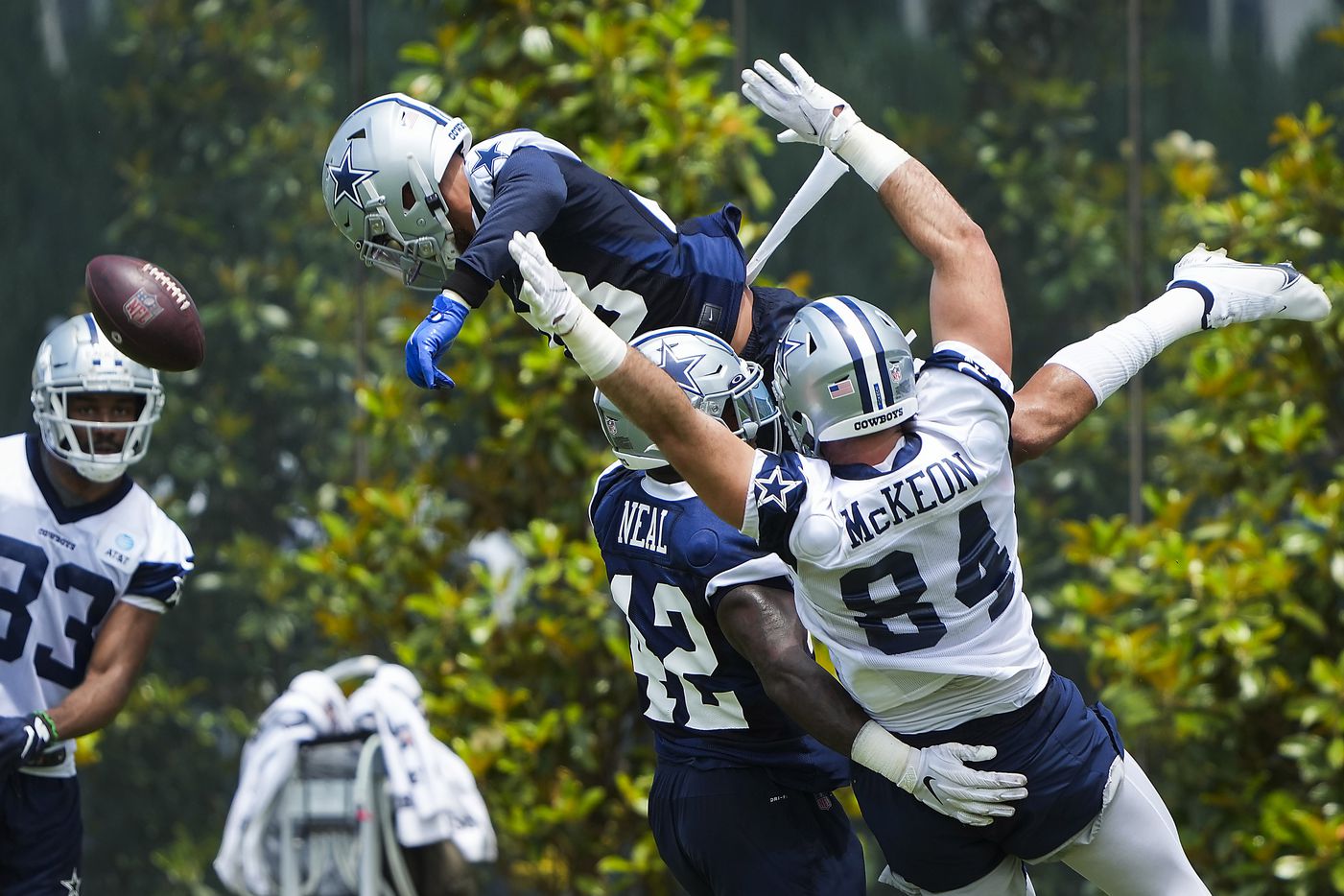 Dallas Cowboys safety Darian Thompson (23) leaps over tight end Sean McKeon (84), linebacker Keanu Neal (42) and wide receiver Brennan Eagles (83) to break up a pass during a minicamp practice at The Star on Tuesday, June 8, 2021, in Frisco. (Smiley N. Pool/The Dallas Morning News)