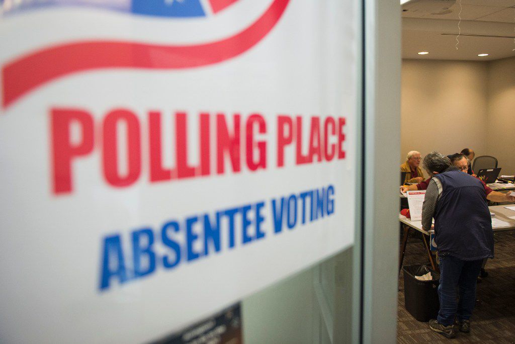 A woman registers to vote at an absentee voting station in Arlington, Va. (Andrew Caballero-Reynolds/Agence France-Presse)