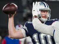 Dallas Cowboys quarterback Cooper Rush (10) throws a pass under pressure from New York...