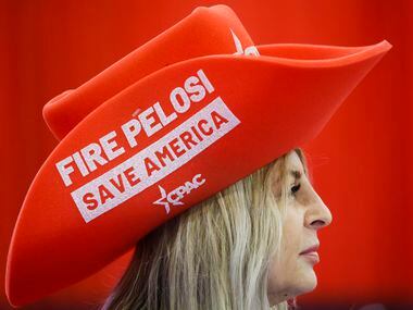 Volunteer Teresa Winata wears a hat reading “Fire Pelosi Save America” during the second day...