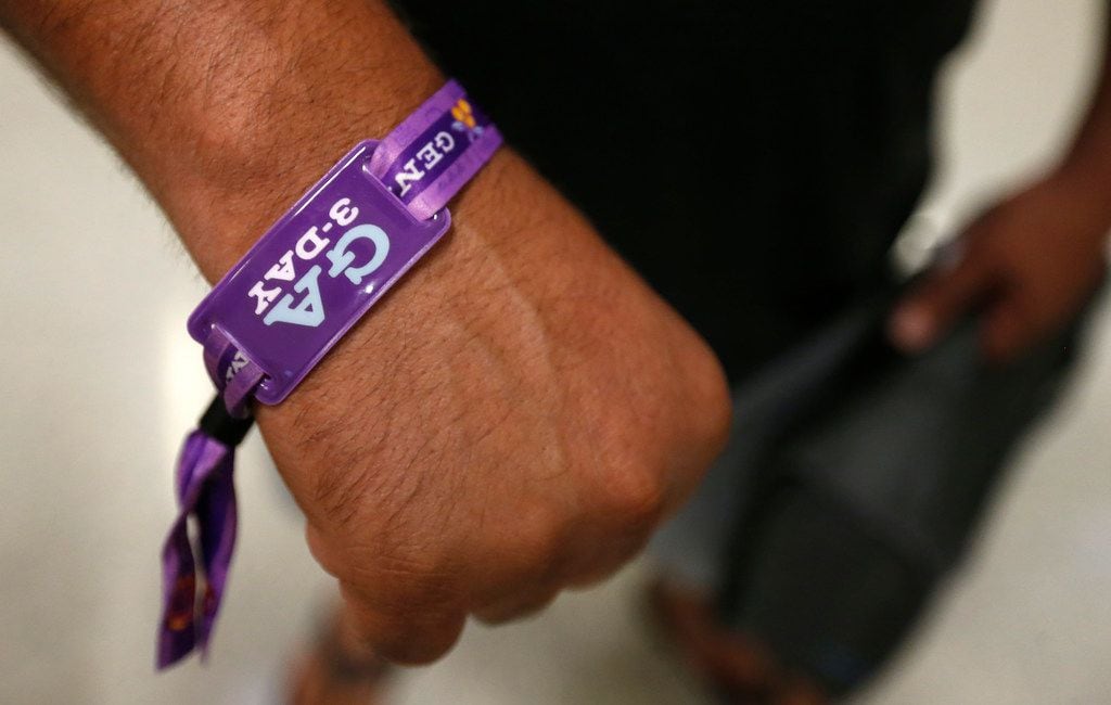 Joe Illiano, of Frisco, shows a festival wristband as he arrives at Dallas/Fort Worth...