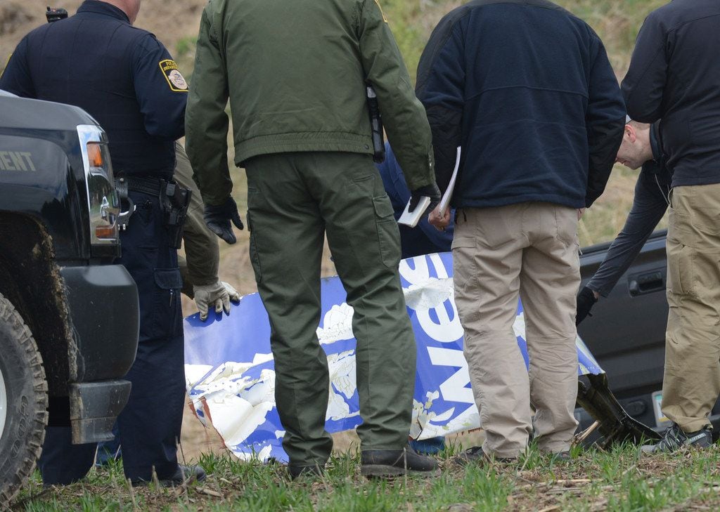 National Transportation Safety Board investigators in Penn Township on Wednesday examine a piece of debris from the Southwest Airlines plane that made an emergency landing Tuesday after a fatal engine mishap.
