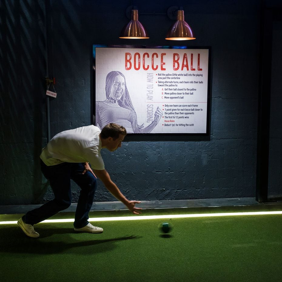 Josh Winkler plays bocce ball at Sidecar Social in Addison.