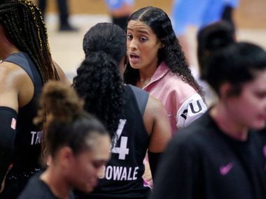 Dallas Wings guard Skylar Diggins-Smith (facing) coaches Dallas Wings guard Arike Ogunbowale (24) during a first quarter timeout against the Atlanta Dream at College Park Center in Arlington, Texas, Sunday, August 25, 2019.
