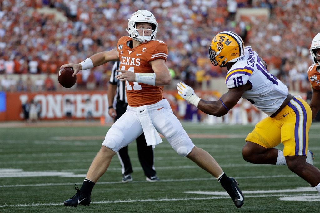 Texas quarterback Sam Ehlinger (11) is pressured by LSU linebacker K'Lavon Chaisson (18) during the first half of an NCAA college football game, Saturday, Sept. 7, 2019, in Austin, Texas. (AP Photo/Eric Gay)