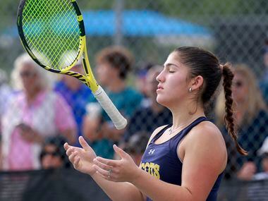 Highland Park’s Eden Rogozinski lightly tosses her racket during the 5A girls doubles...