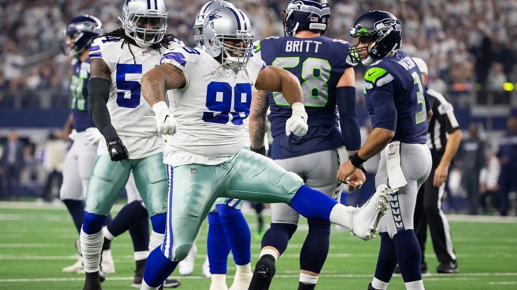 Cowboys defensive tackle Antwaun Woods (99) celebrates after sacking Seattle Seahawks quarterback Russell Wilson (3) during the first half of an NFL wild-card playoff football game at AT&T Stadium on Saturday, Jan. 5, 2019, in Arlington.
