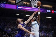 Dallas Mavericks guard Kyrie Irving (11) shoots over Sacramento Kings forward Domantas...