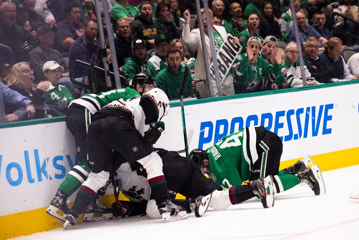 Fans react as the Dallas Stars and Arizona Coyotes fight for the puck during the first...