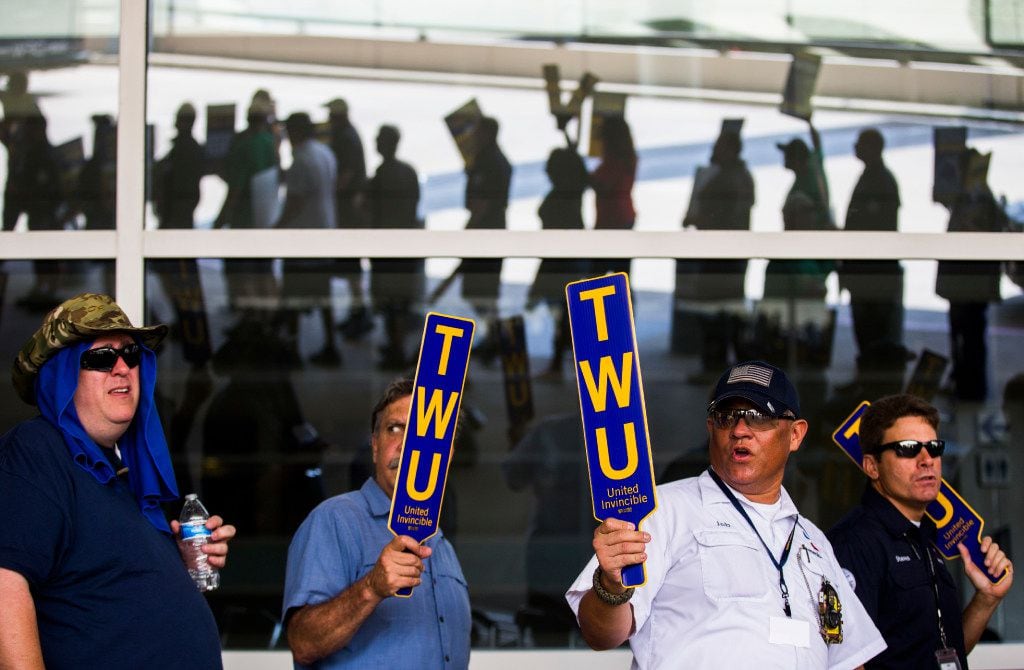 American Airlines employees protest the lack of a new contract for baggage carriers, mechanics and other staff on Wednesday, July 26, 2017 outside Terminal D at Dallas/Fort Worth International Airport. (Ashley Landis/The Dallas Morning News)