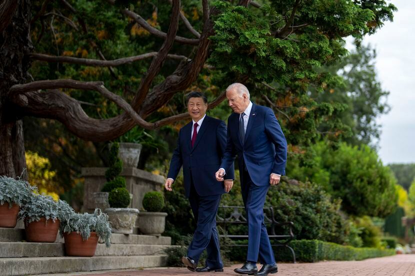 President Joe Biden and China's President President Xi Jinping walk in the gardens at the...