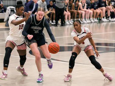 Flower Mound forward Madison Cox (40) tries to get past Denton Braswell guard MaKayla Vation...