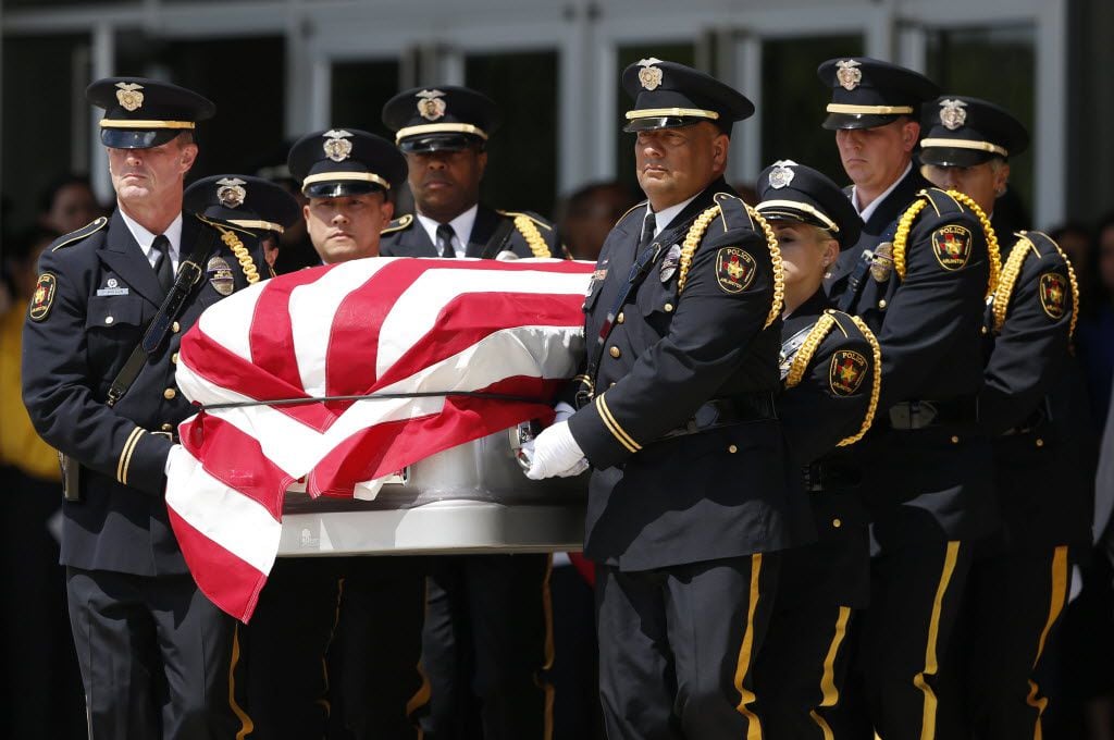 The Arlington Honor Guard carried the casket of DART police Officer Brent Thompson during a...