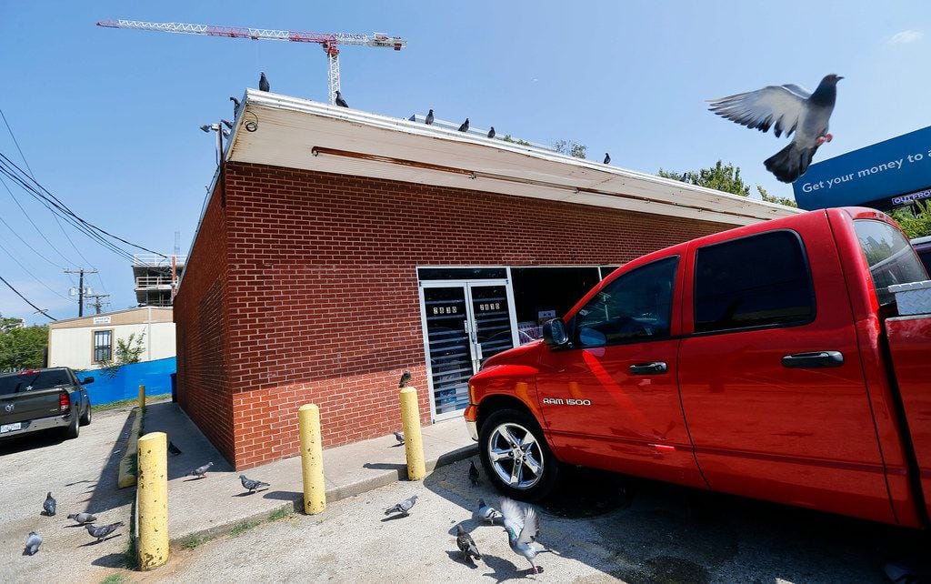 Pigeons roost on the Villasana Food Store owned by Charlie Villasana, a longtime Little Mexico resident who has put off selling his property in the area, which is worth more than $1.3 million. He is nearly 88 and struggles with deciding what to do with the store.