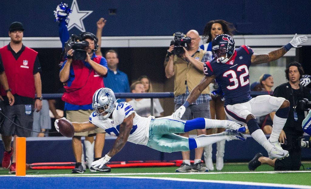Dallas Cowboys running back Tony Pollard (36) dives toward the goal line ahead of Houston...