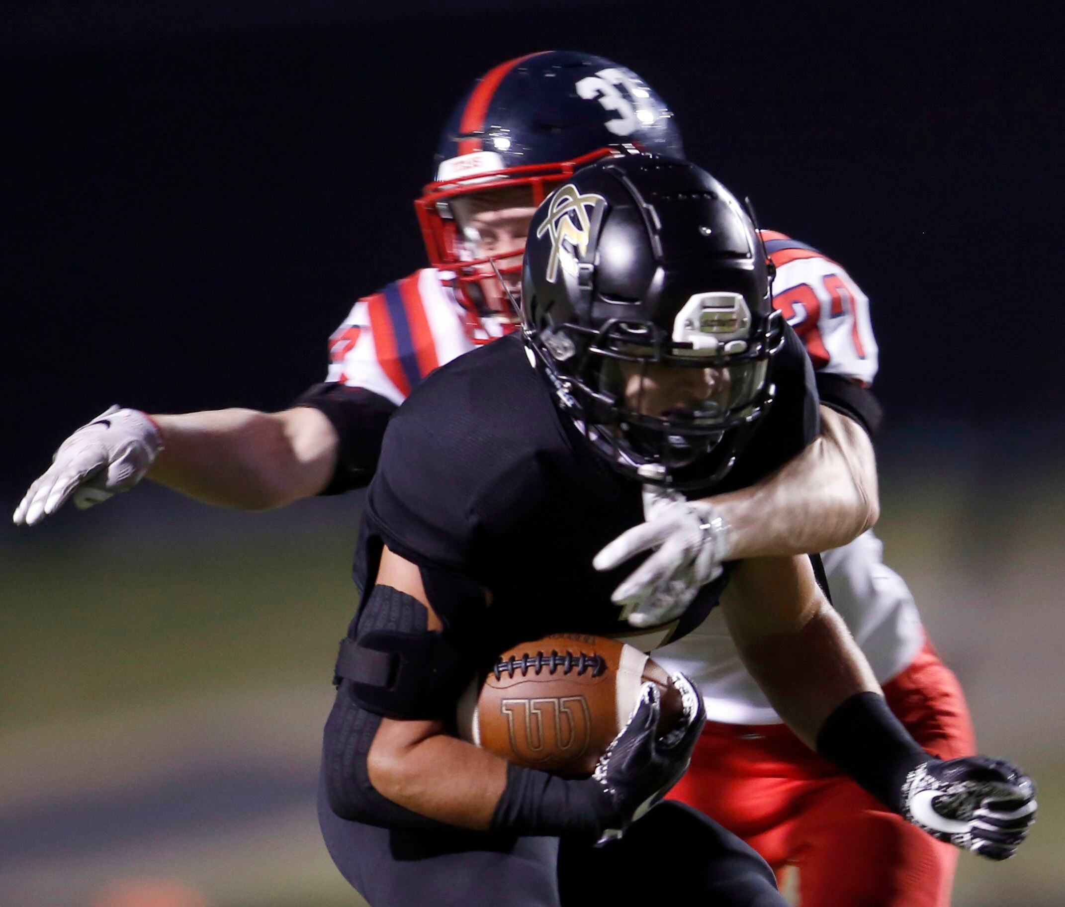 Royse City running back Tyson Neighbors (5) feels the crunch of the tackle from Frisco...