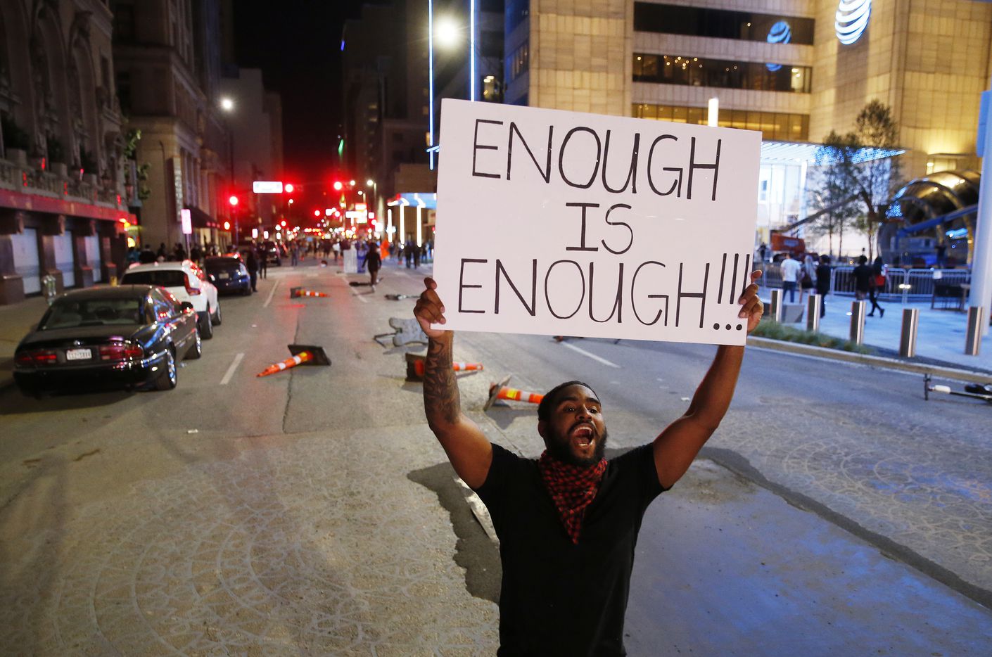 A protestors yells toward police as he walks up Commerce during a march against police...