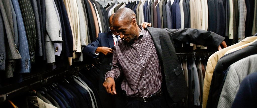 With job interviews in mind, Joshua Miller tries on a suit at the Southwest Workforce...