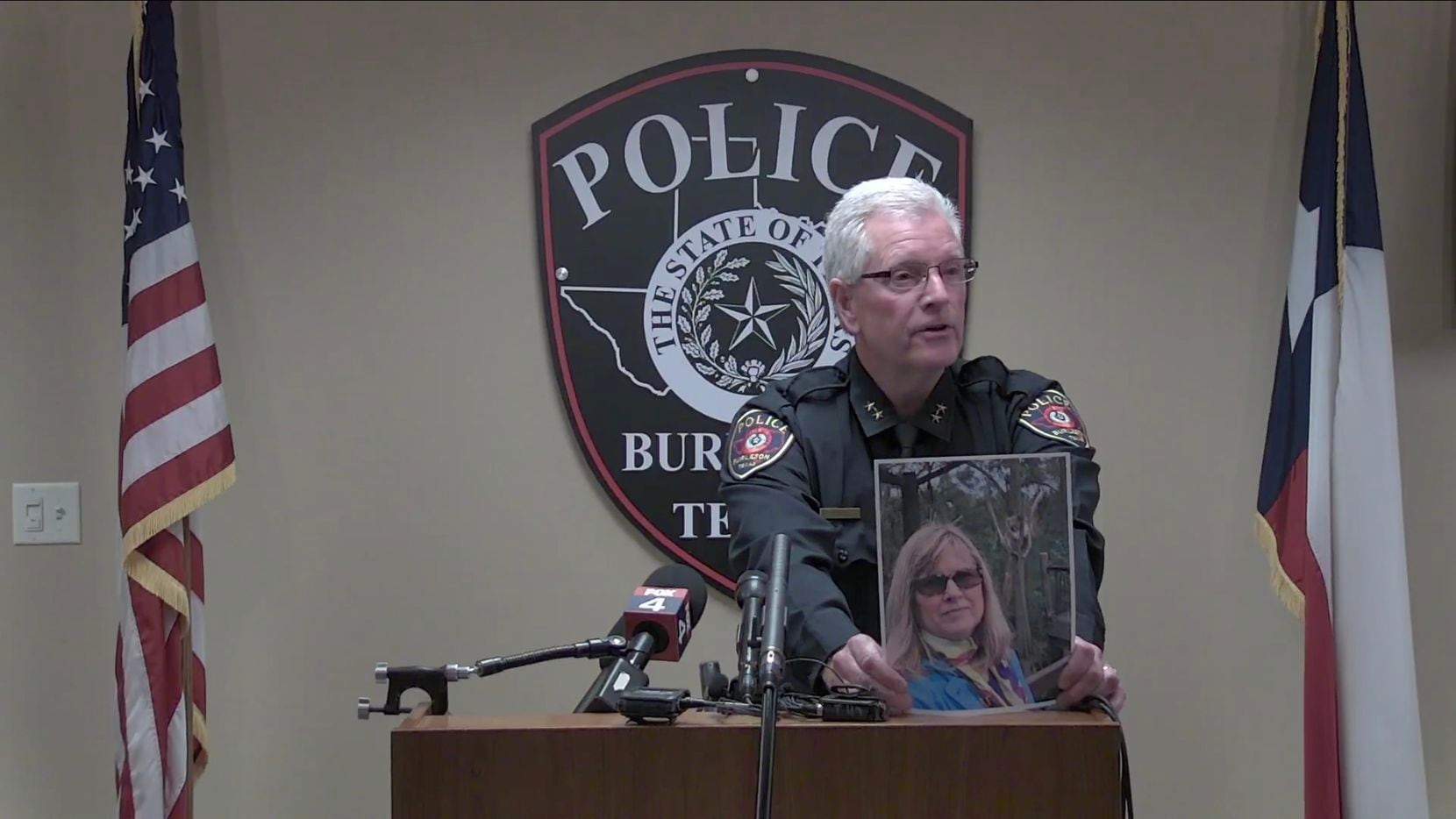 Burleson Police Chief Billy Cordell holds up a photo of Kathryn Bryan, 64, during a news...
